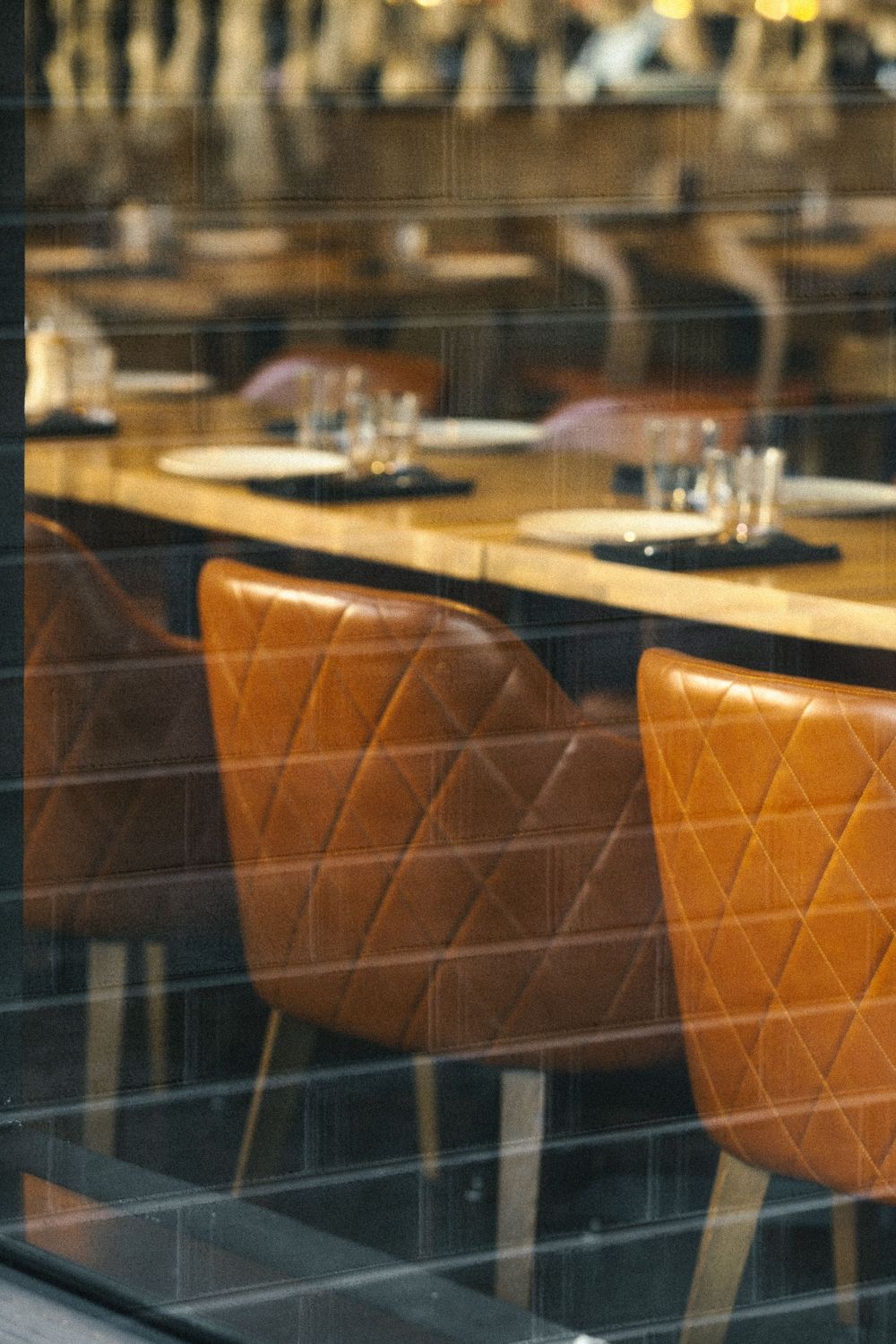Close-up view of brown leather booth seating in a restaurant interior.
