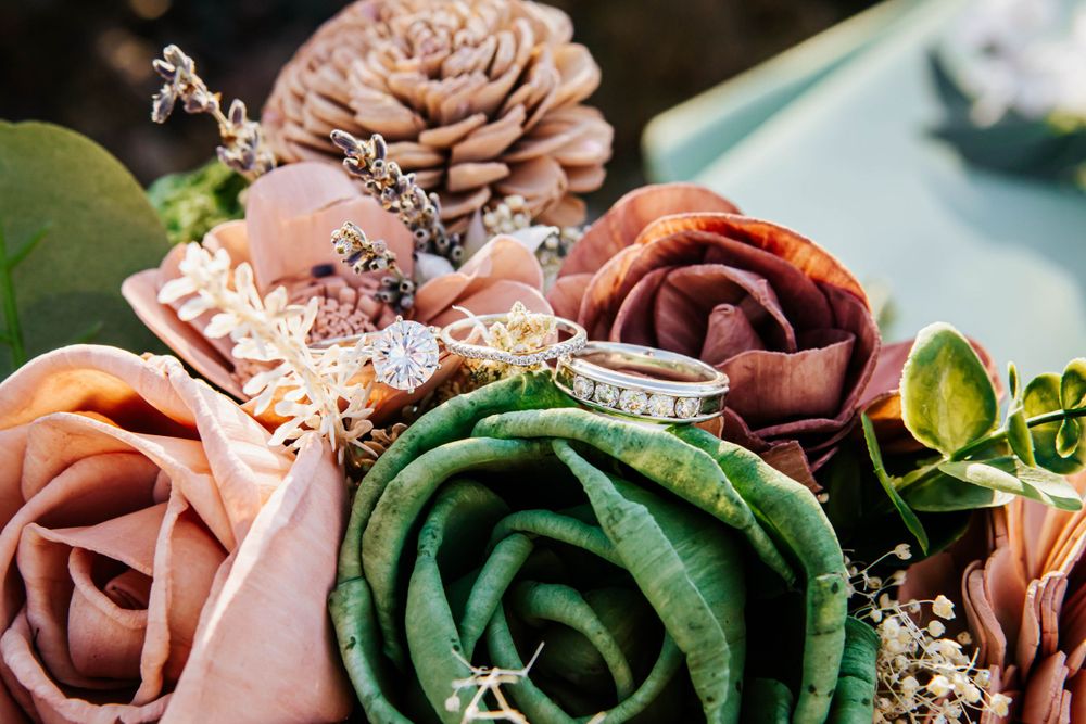 Close-up of wedding bouquet with pink, green, and mauve silk roses.