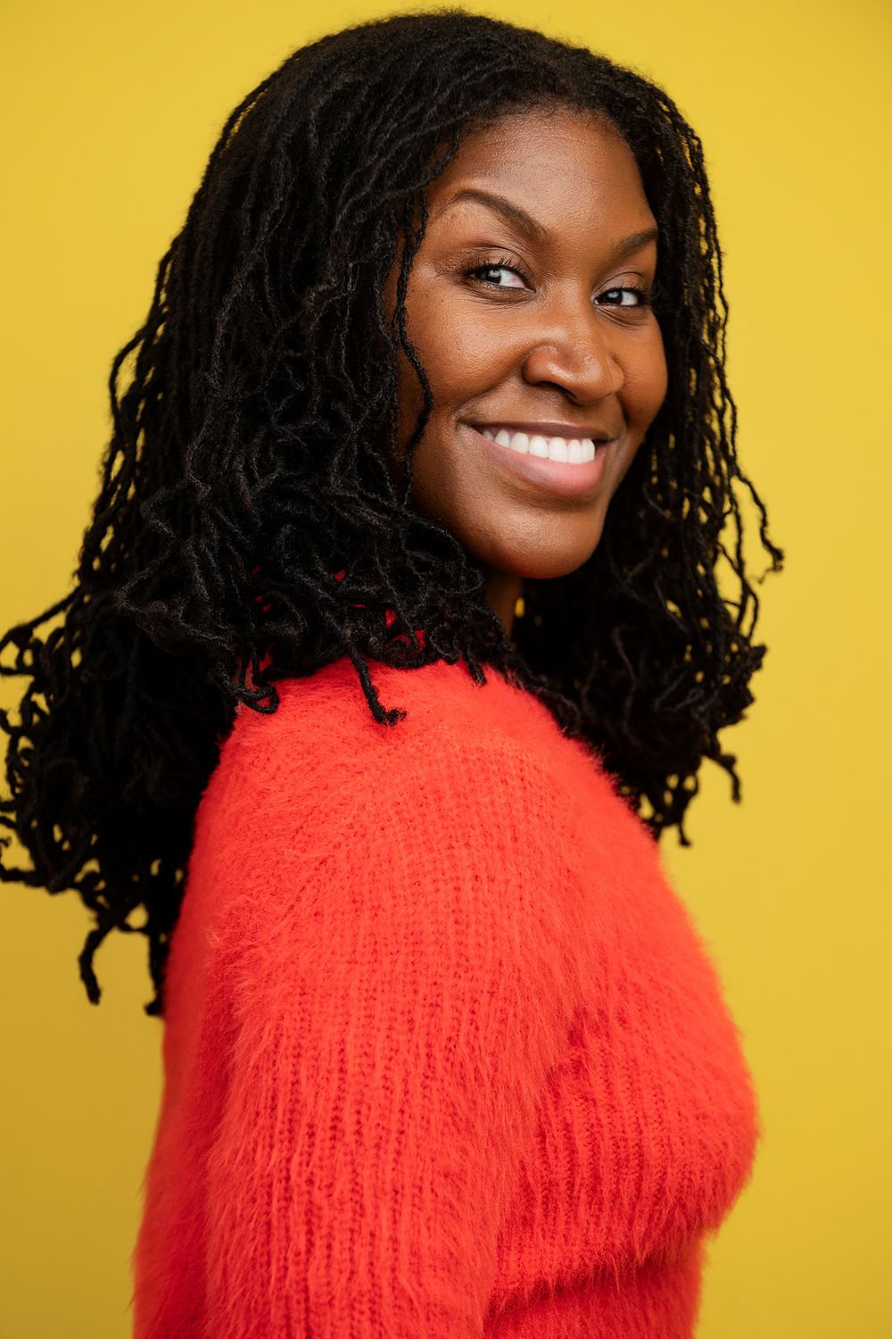 Casting-ready headshot of a Black male actor taken in studio, showcasing natural expression and clean yellow background full personality