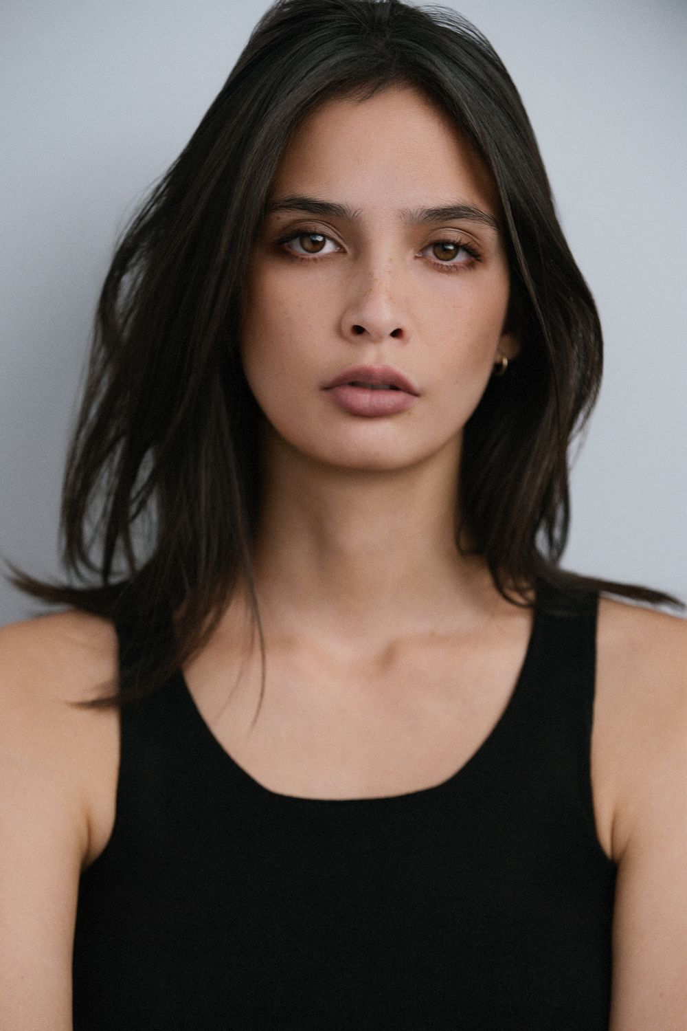 Professional studio actor headshot of a female actor photographed against a solid color backdrop with cinematic lighting