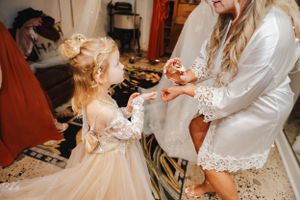 A touching moment during wedding preparations in a getting-ready room.