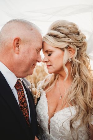 Romantic close-up portrait showcasing elegant bridal hairstyle and intimate moment.
