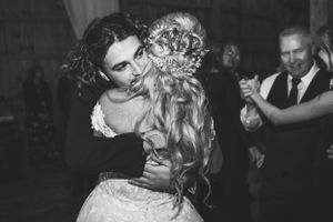 A romantic black and white photo captures a couple dancing at their wedding reception.