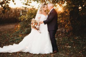 Wedding couple shares intimate moment during golden hour portrait session in nature.