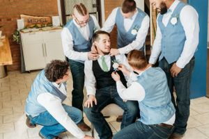 Groomsmen having fun and joking around before the wedding ceremony.