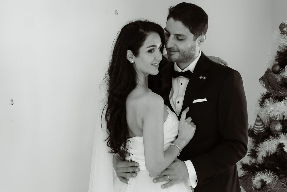 Black and white romantic portrait of newlyweds in classic wedding attire.