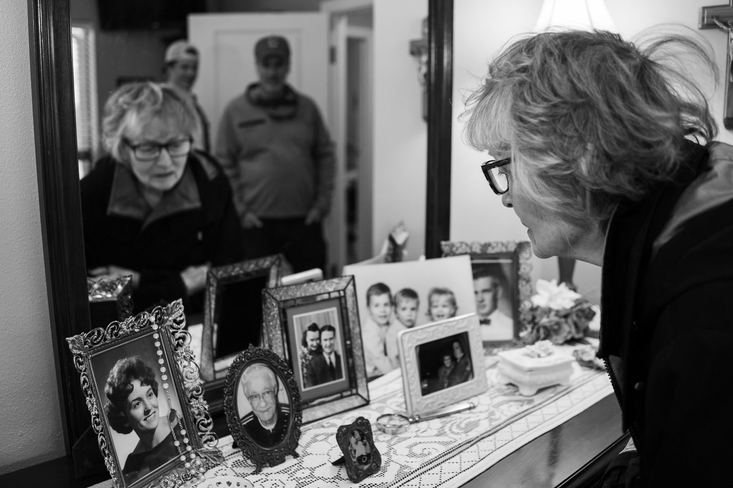 Woman with dementia looking at old photographs taken by lifestyle photographer in Jefferson County, TN.