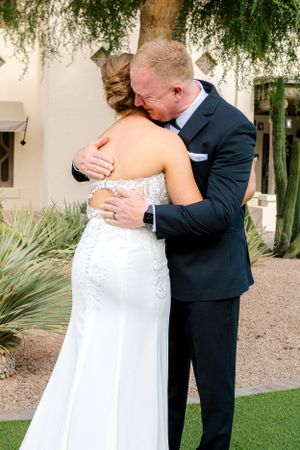 Intimate wedding moment captured in a garden setting with desert landscaping.