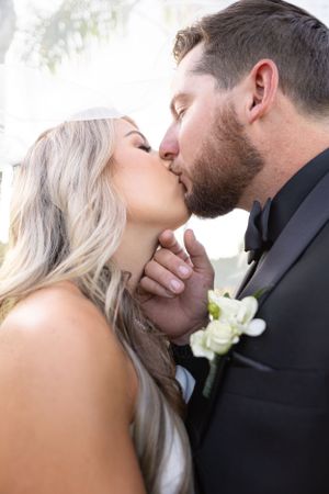 Intimate close-up portrait of newlyweds sharing a tender moment.