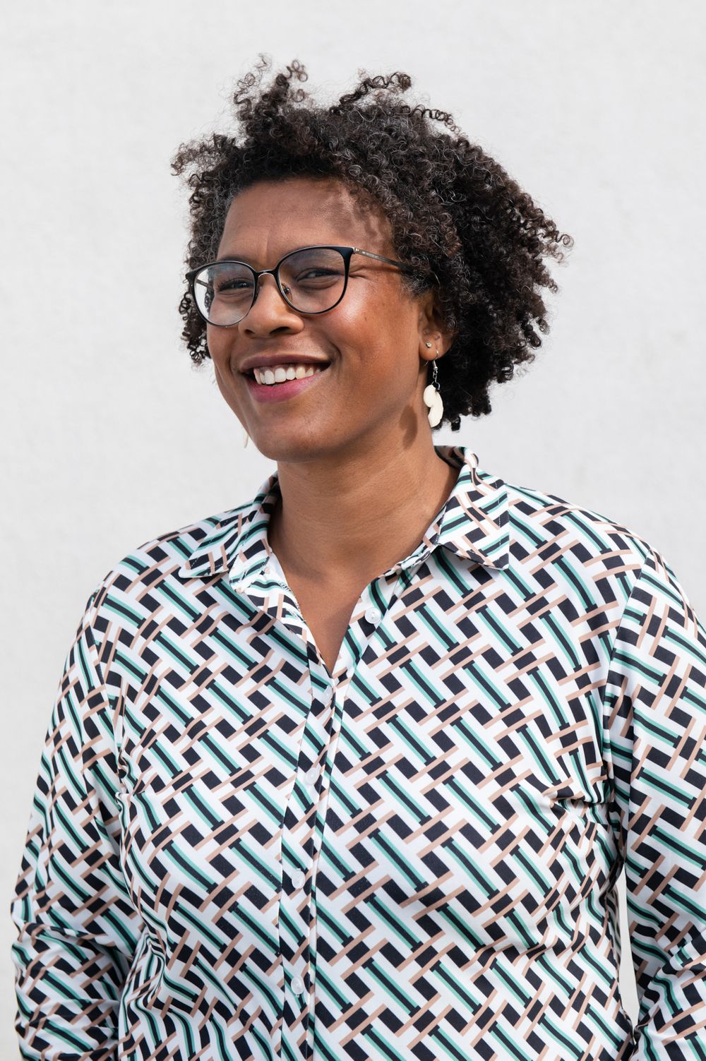 Portrait series showing someone in a patterned black and green geometric print shirt.