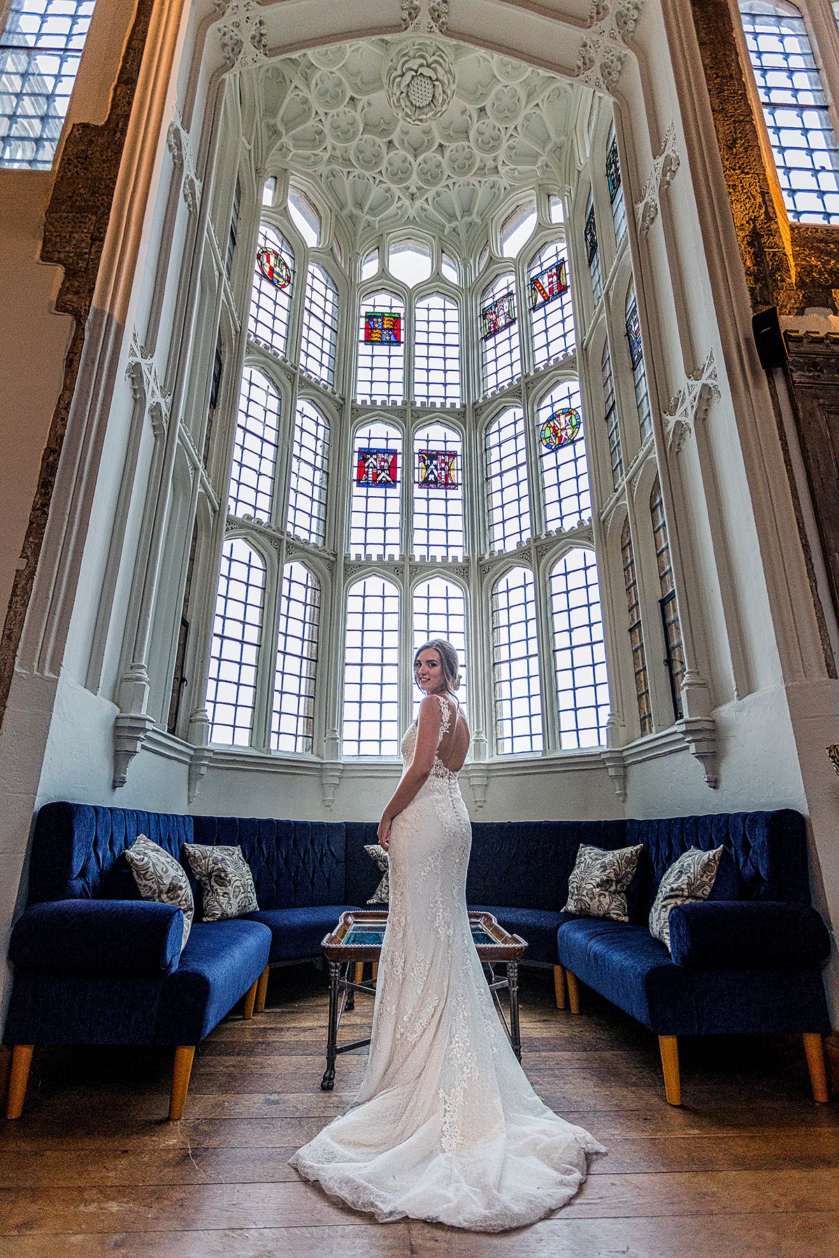 bride standing  in a tall tower, by a bay window inside the great hall at falsely hall