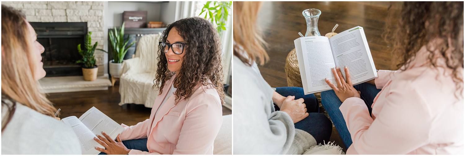 Woman talking with female client in living area and reading health book