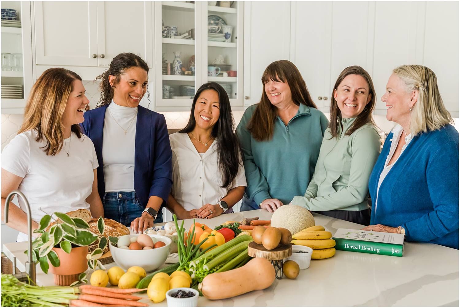 Women gathered around nutrition food on kitchen island