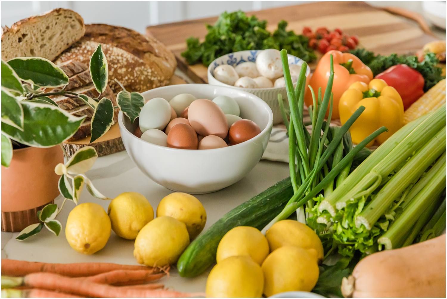 Healthy fruits, vegetables and eggs laid out on counter
