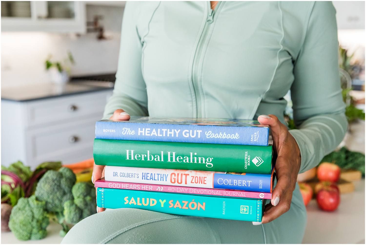 Closeup of woman holding a stack of health books