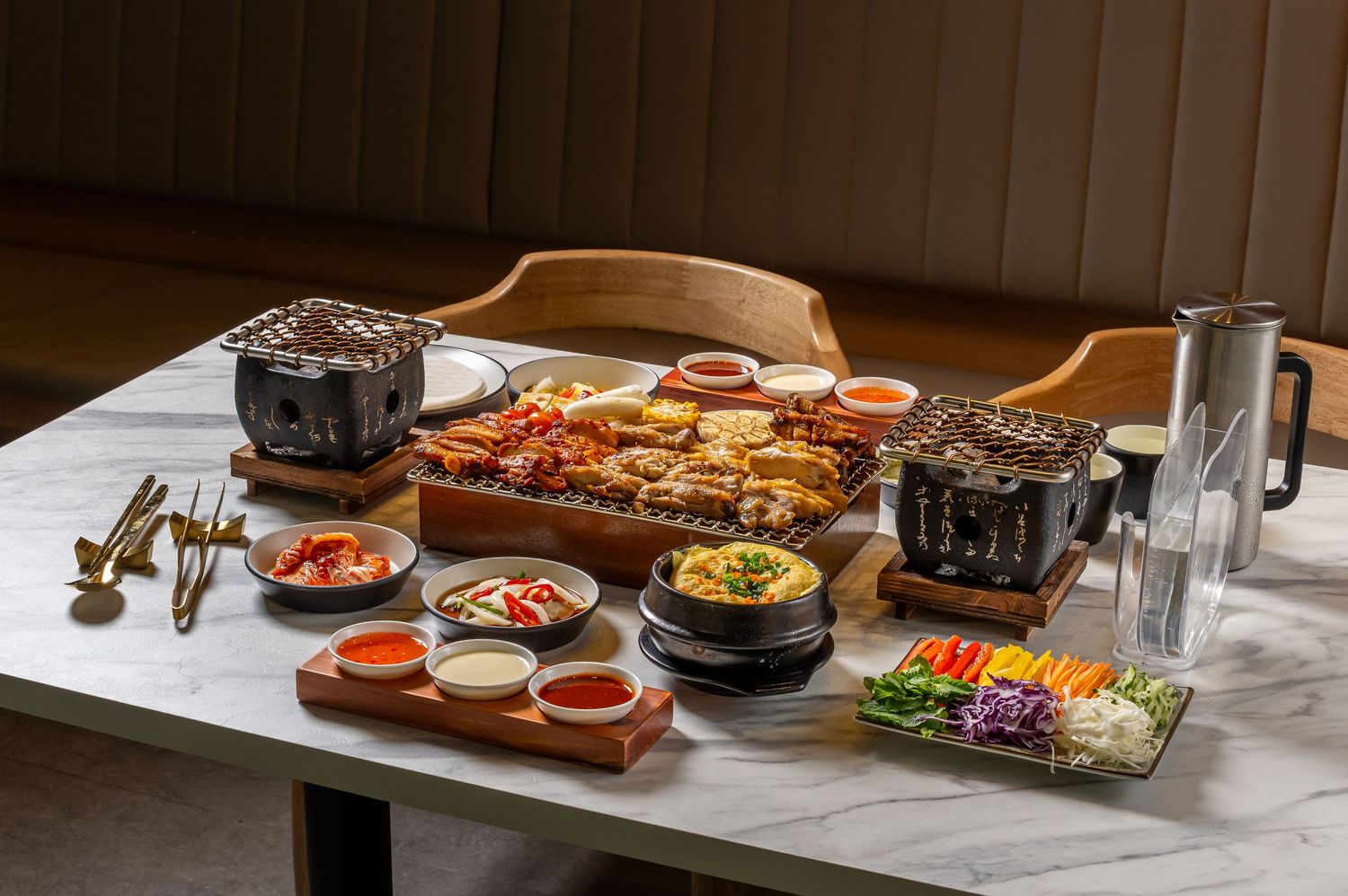 Asian restaurant table setting with various dishes and condiments arranged for dining.