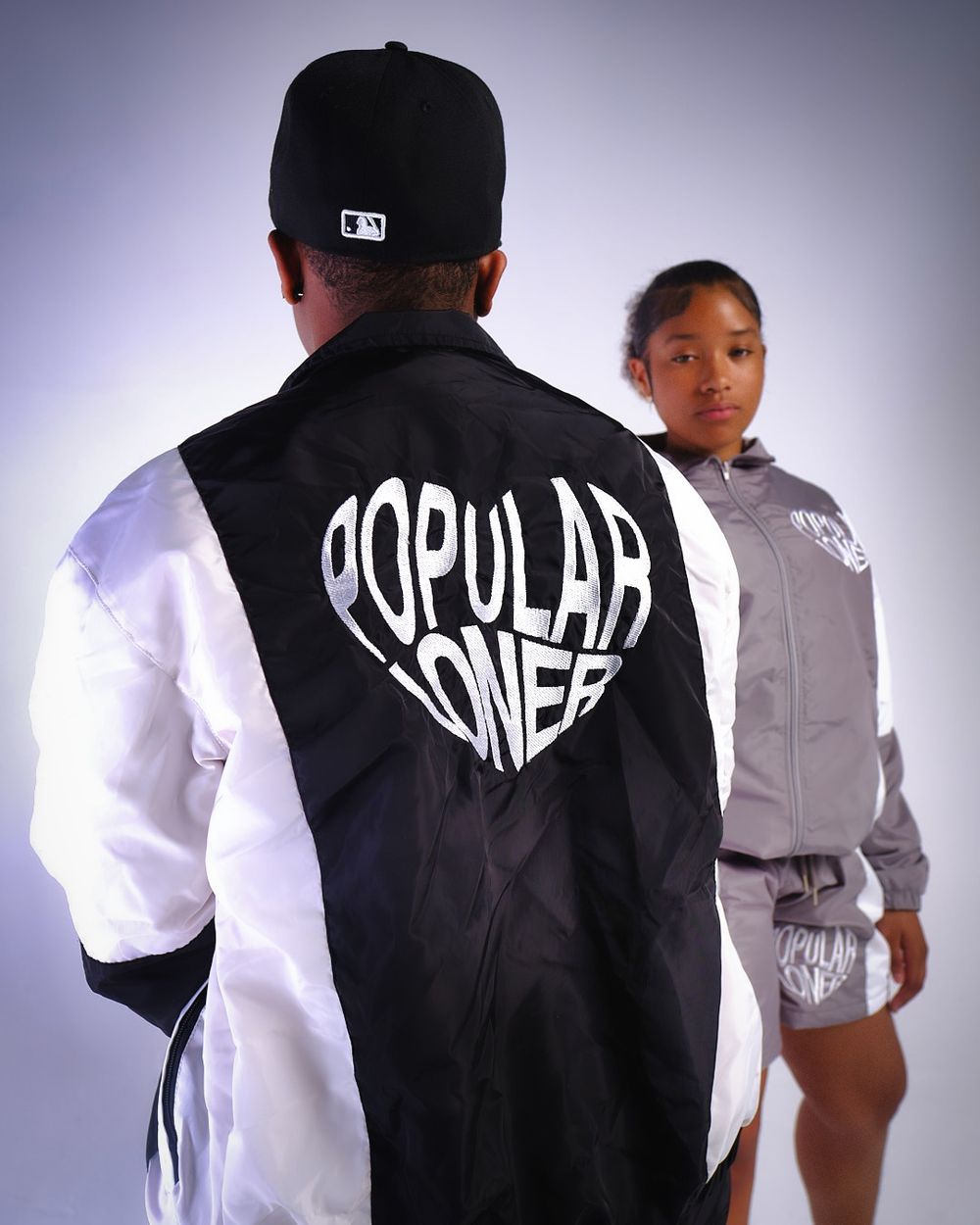 Back view of jacket with 'Popular One' text graphic in black and white design.