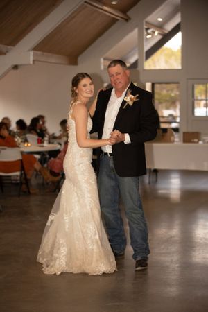 A sweet dance moment captured during the wedding reception in a modern venue.