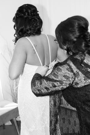 Black and white photo of dress preparation with lace details.