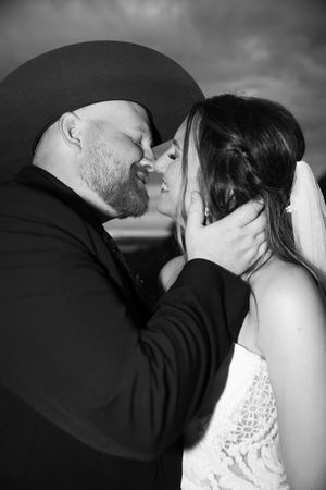 A romantic black and white photo sequence showing a couple sharing an intimate kiss.
