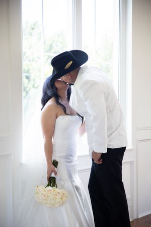 Romantic wedding photos showing couples in white and black attire sharing tender moments by bright windows.