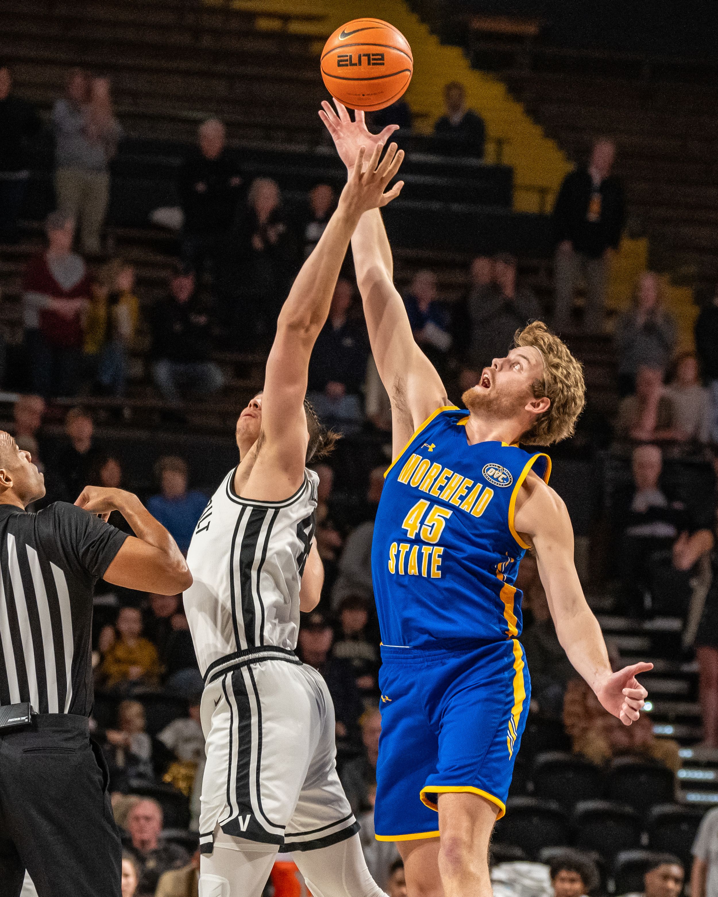 Morehead State player number 45 contests a shot against Wake Forest player during college basketball game.