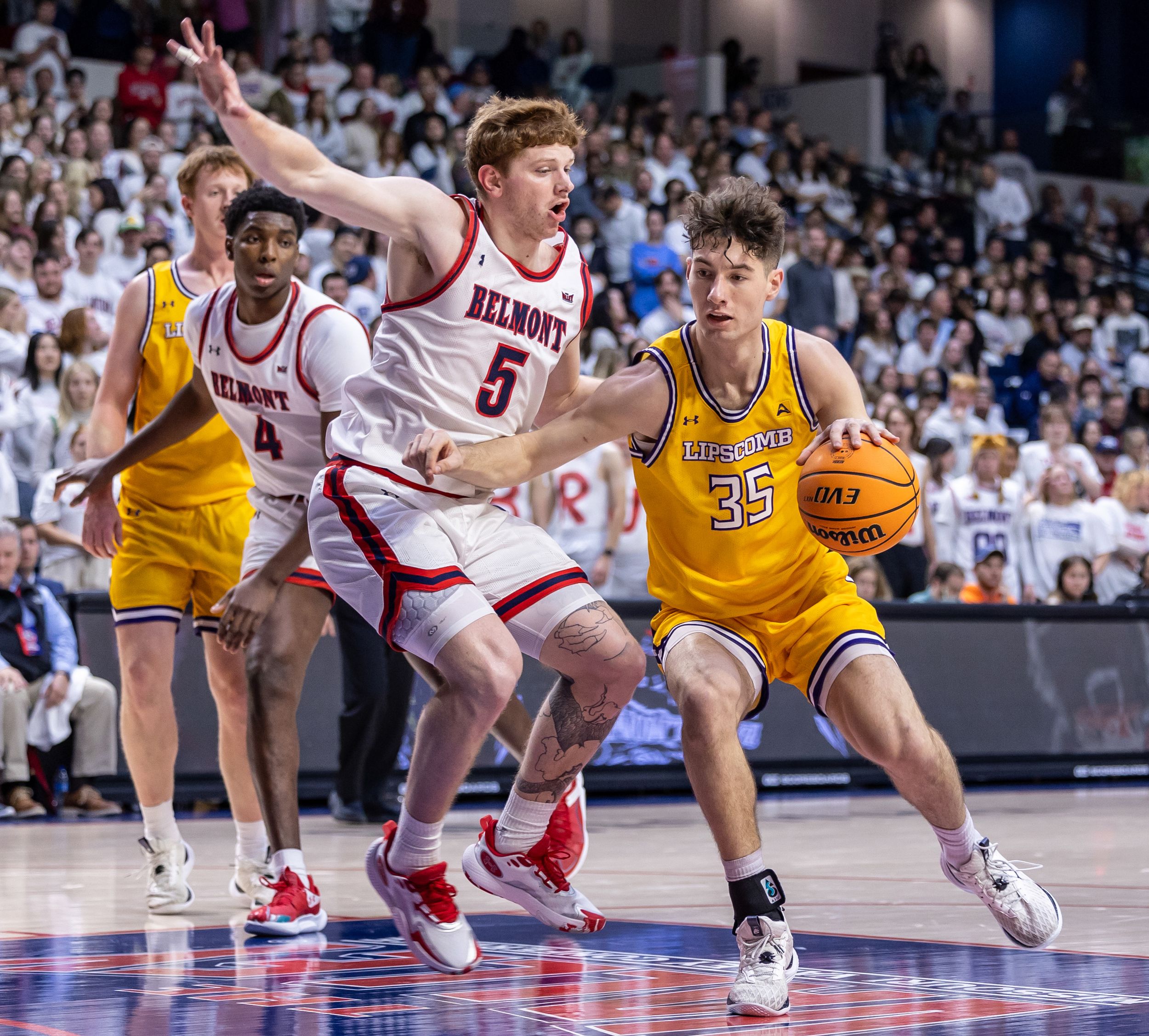 Belmont basketball player number 5 defends against opponent number 35 during an intense college basketball game.