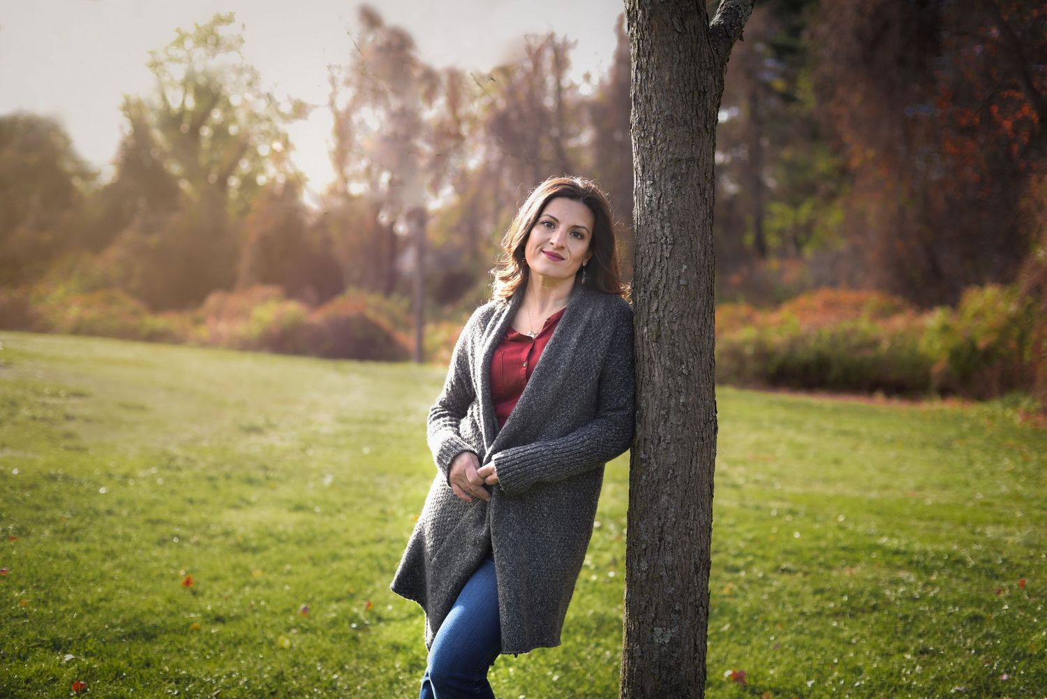 Branding portrait of a woman leaning against a tree in Red Bank NJ