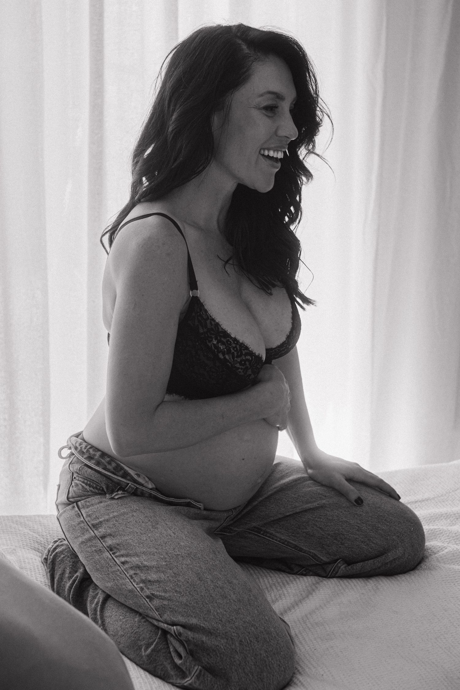 A black and white photo series showing a person in jeans lounging on a bed in various relaxed poses.