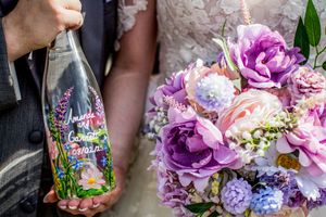 Purple and pink floral wedding bouquets with mixed flowers and greenery.