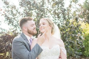 Romantic sunset wedding portraits in a garden setting with natural golden light.