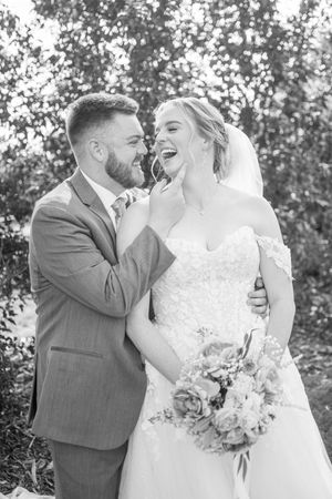 Black and white wedding portraits capturing intimate moments between the newlyweds.
