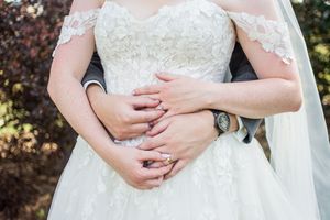 Close-up details of intricate lace wedding dress bodice and delicate veil.