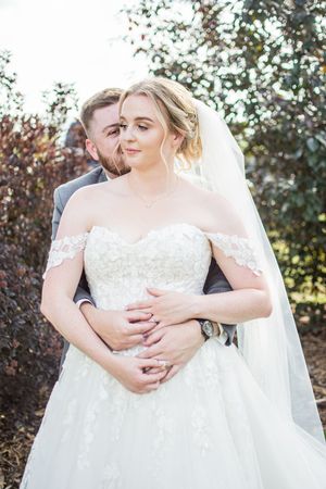 Close-up series of romantic embraces between newlyweds against a leafy background.