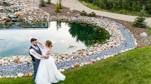 Panoramic view of a winding stone path through a beautifully landscaped wedding venue garden.