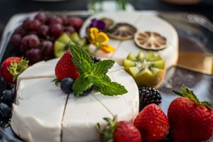 Close-up of fresh fruit and dessert platter with berries, grapes, and mint garnish.