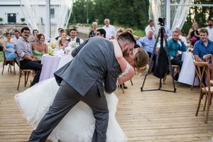 Wedding dance sequence showing movement and celebration under a clear tent.
