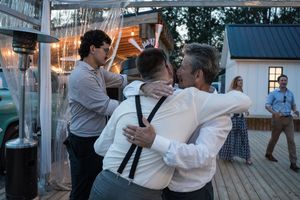 Wedding guests dancing and celebrating at an evening outdoor reception.