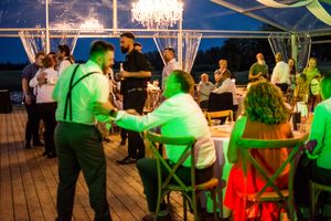 Wedding reception dance floor with green lighting and sparklers creating a festive atmosphere.