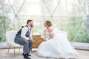 Romantic wedding photo shoot in elegant white draped gazebo with natural lighting.