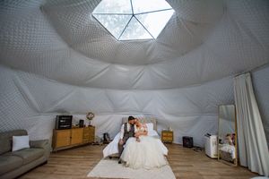 Interior view of a white geodesic dome structure with natural light coming through the top window.