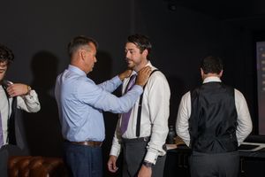 Wedding party members getting ready in formal attire before the ceremony.