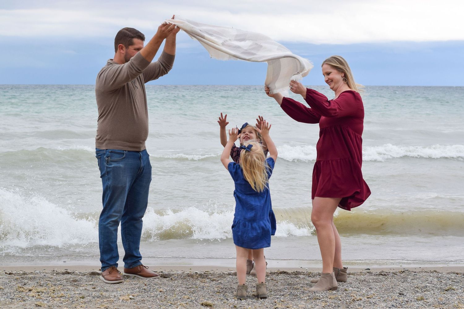 A series of five photos showing people walking and playing along a sandy beach shoreline with ocean waves.