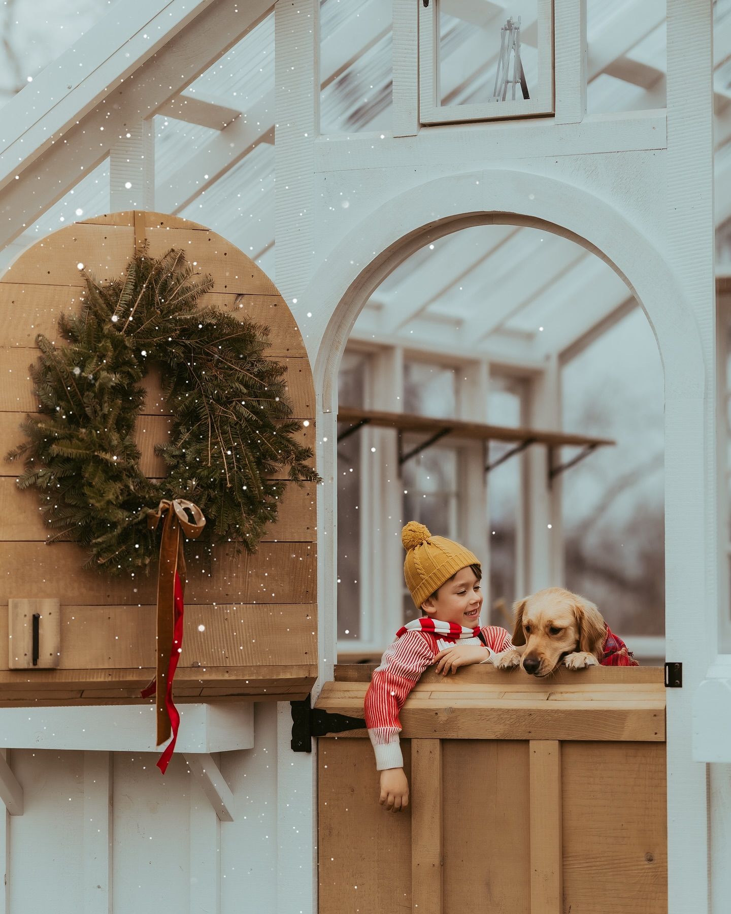 A series of decorative Christmas wreaths and holiday ornaments displayed on rustic wooden wall shelves.