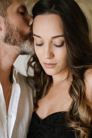 Intimate romantic maternity portrait series in warm tones with soft lighting and gentle poses.