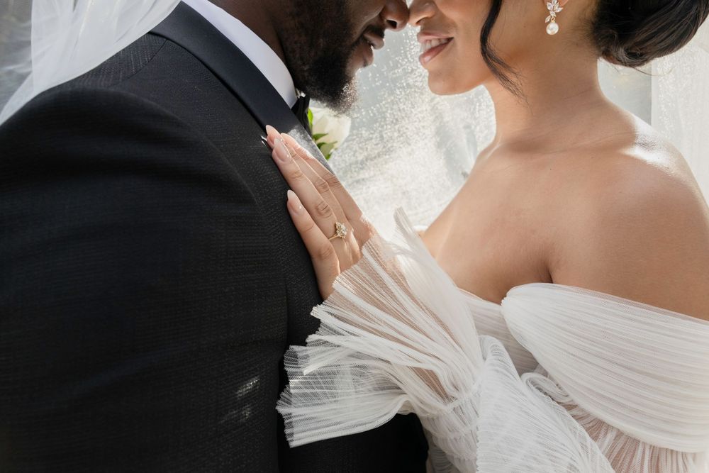 Romantic wedding couple sharing intimate moments during their outdoor ceremony.