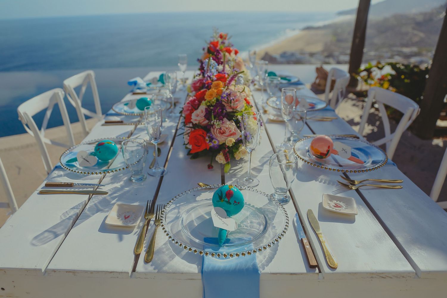 Elegant wedding table setting with colorful floral centerpiece overlooking Pedregal Los Cabos Wedding Photographer
