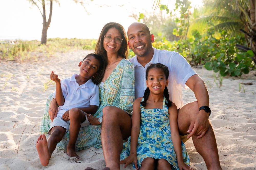 Family of four on the beach in Barbados at golden hour