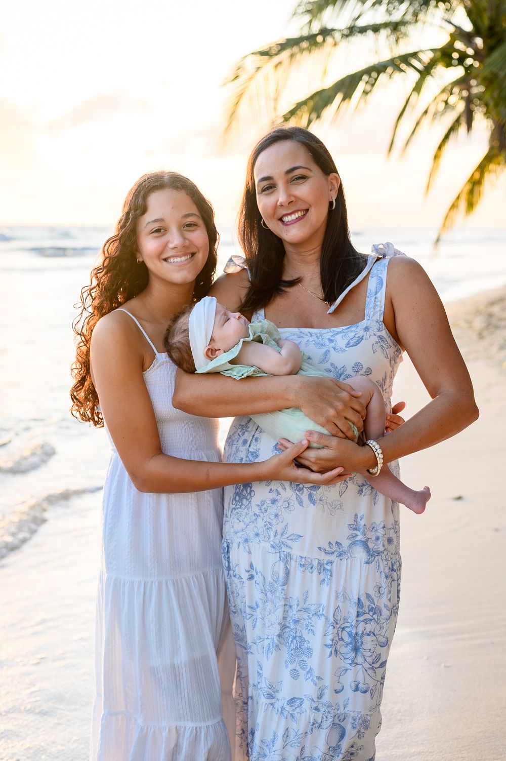 Mother and daughters on the beach in Barbados at golden hour