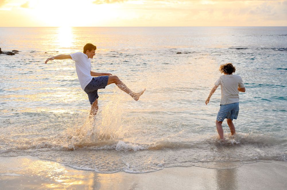 Family on the beach in Barbados at golden hour